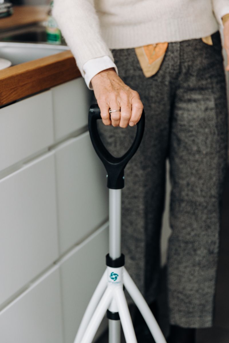 Older person using a walking aid independently