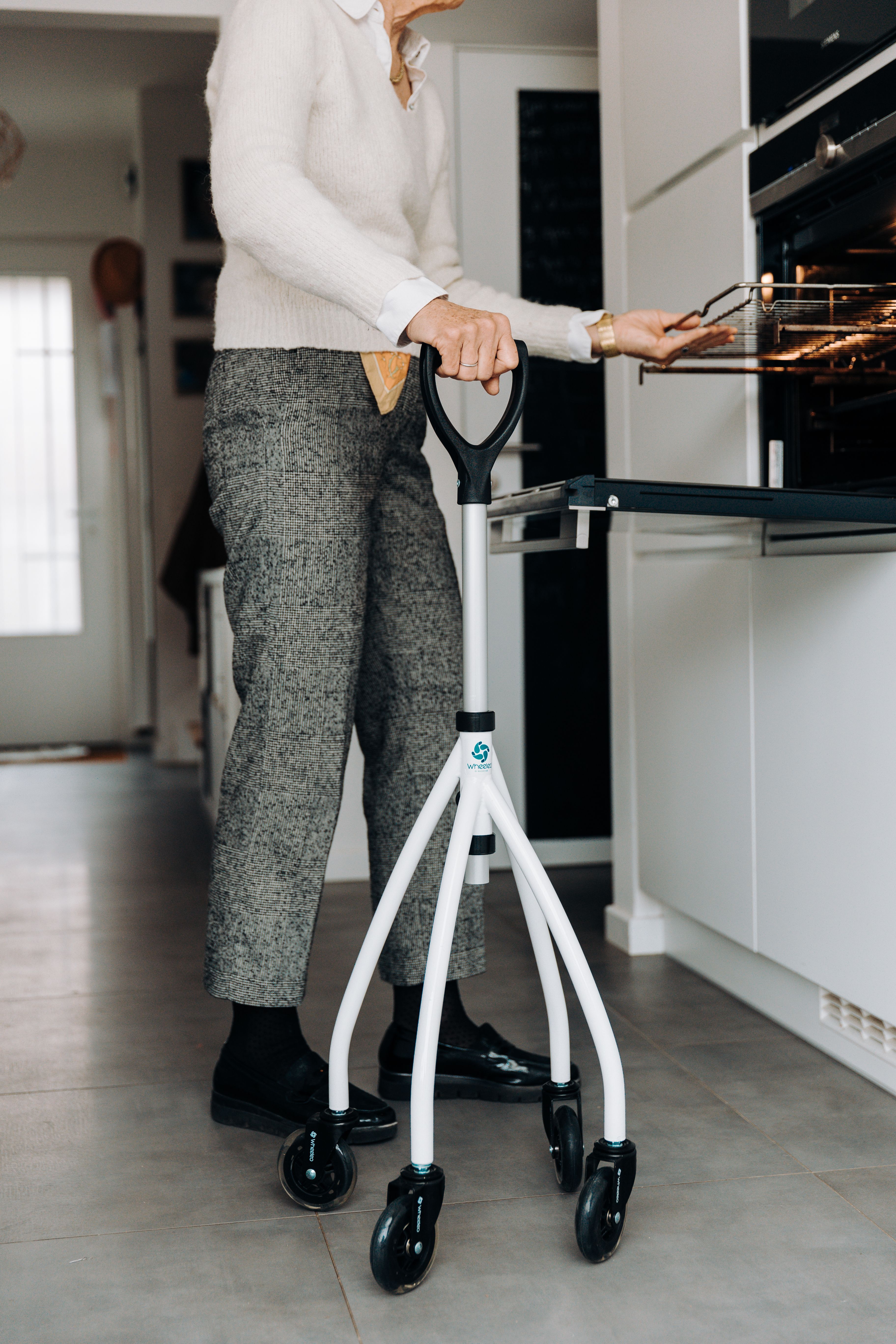 Senior adult using mobility aid in kitchen · Free Stock Photo