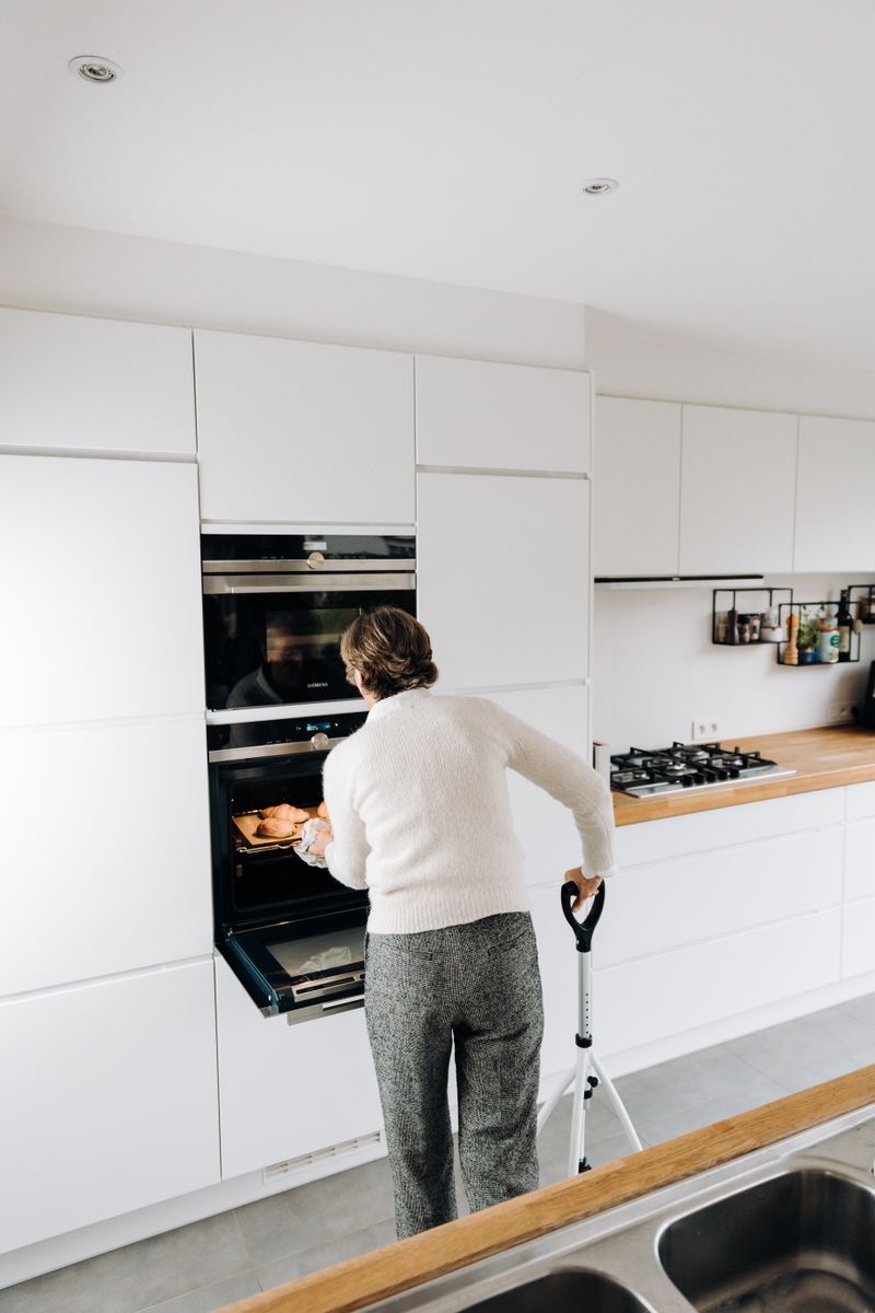 Older person preparing food independently in a modern kitchen