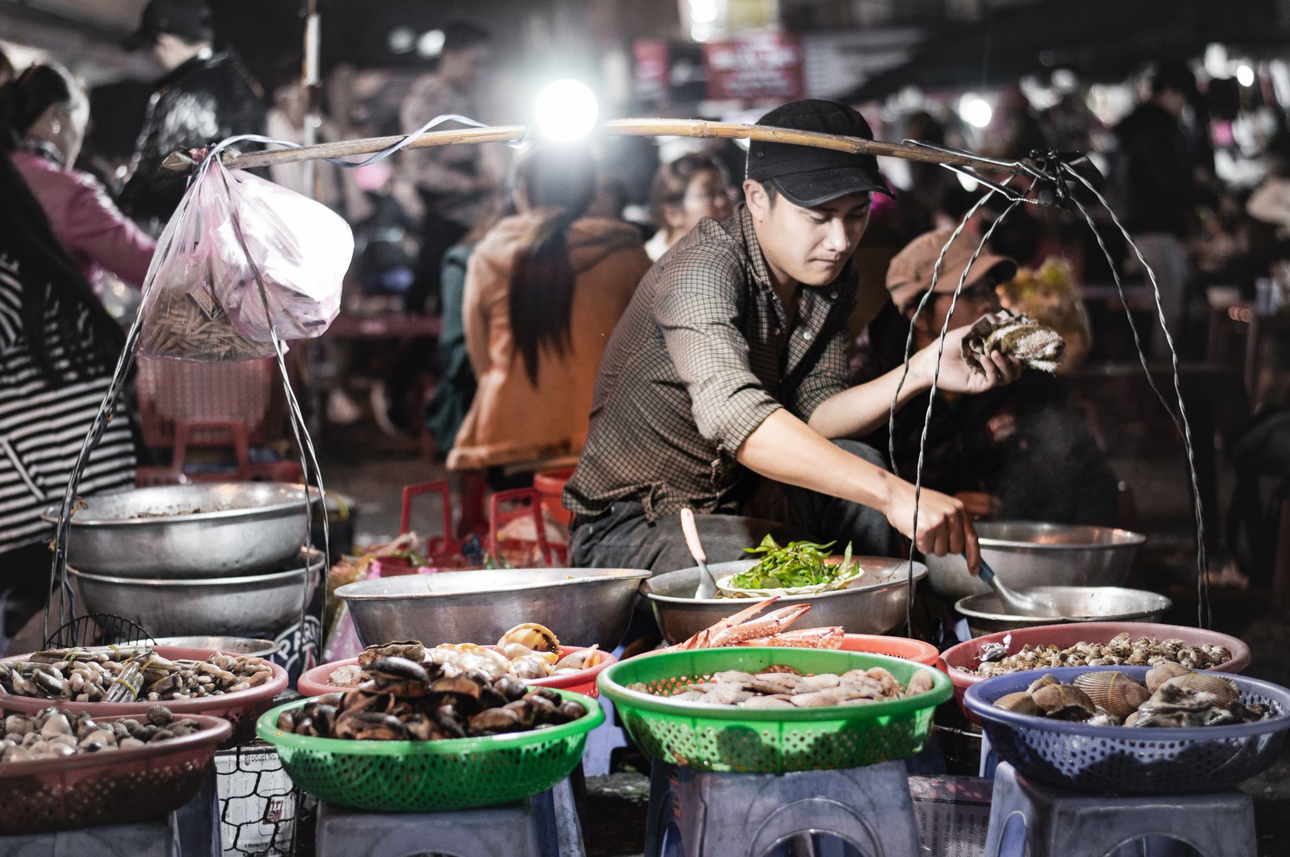 A vibrant scene of a street food vendor at Đà Lạt Night Market, Vietnam.