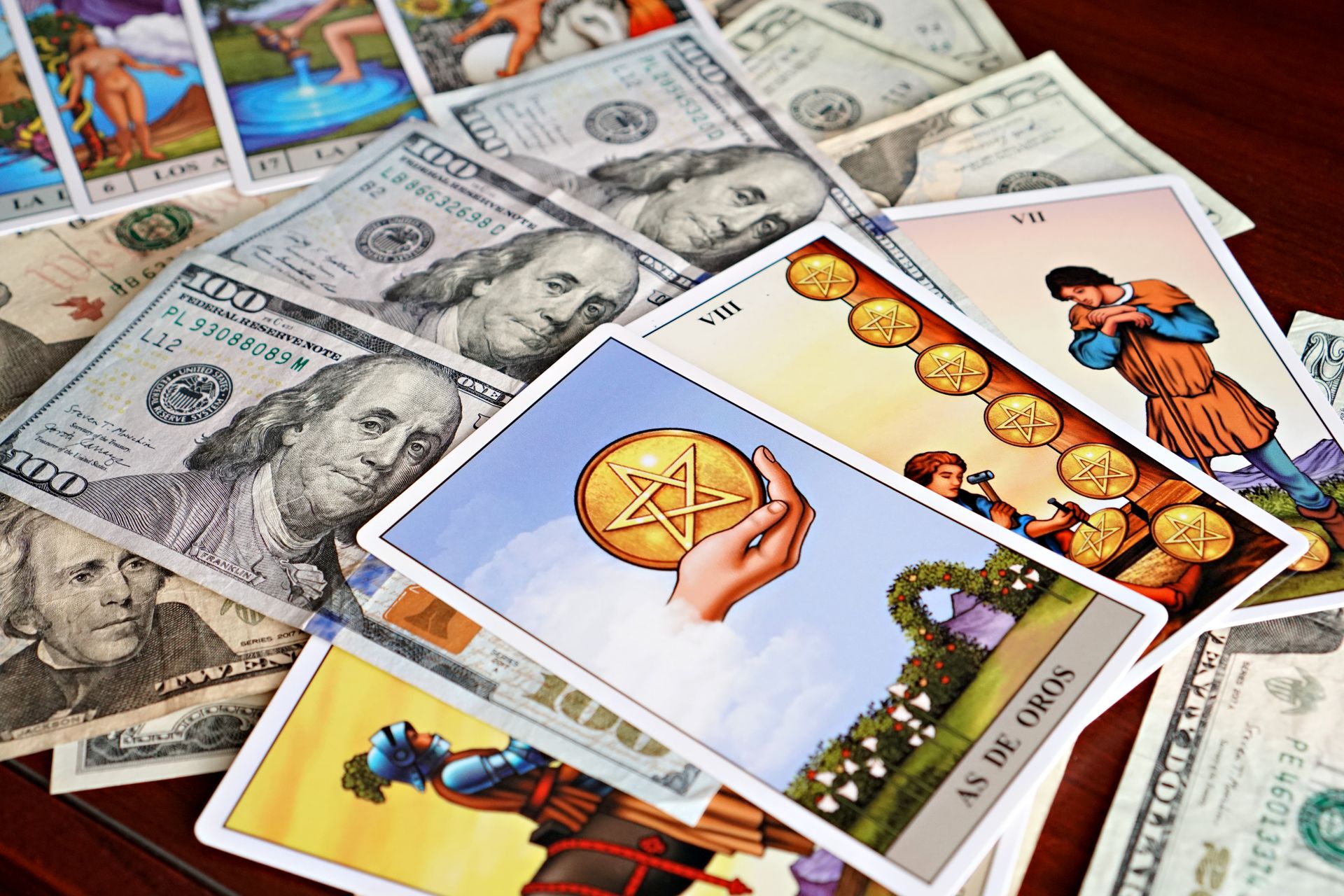 Tarot cards on US dollars representing wealth and fortune telling.
