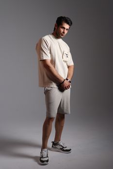 Portrait of a man in minimalistic casual attire with neutral tones.