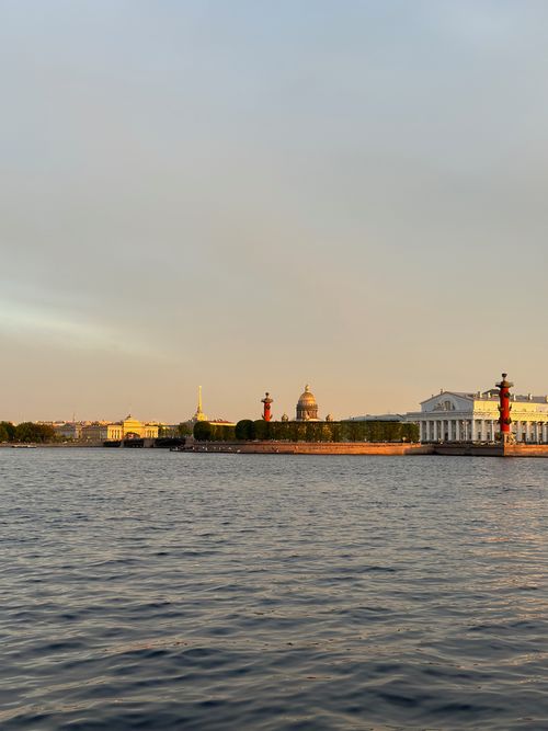 Free Beautiful sunset view of Saint Petersburg waterfront featuring iconic landmarks and calm waters. Stock Photo