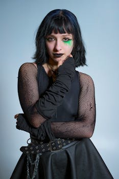 Portrait of a woman in gothic fashion with dark makeup and chains.