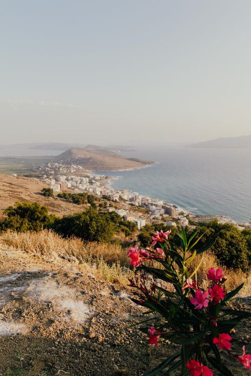 Free Panoramic sunset view of Sarandë's coastline from Lekursi Castle with Mediterranean Sea backdrop. Stock Photo