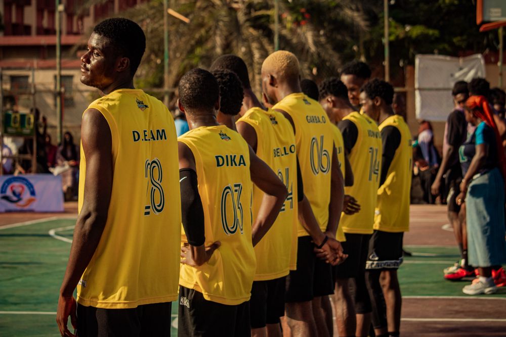 Basketball team wearing yellow numbered jerseys and shorts