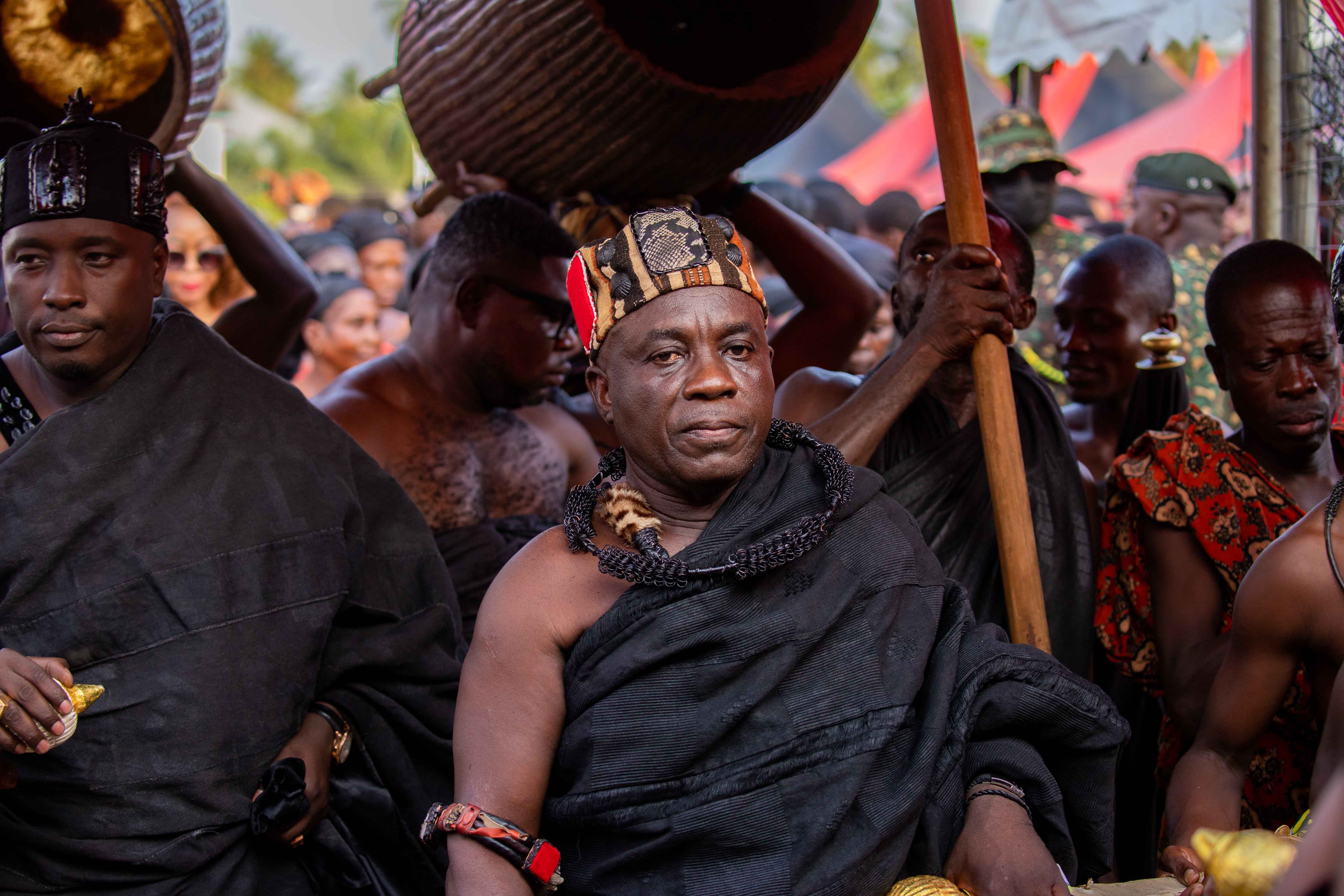 Vibrant traditional ceremony featuring men in cultural African attire, emphasizing rich heritage.