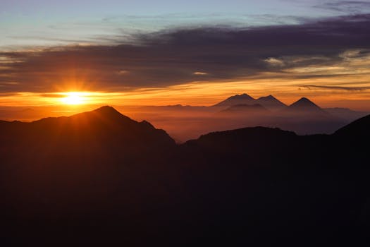 Captivating sunrise illuminating the mountain peaks with vibrant colors.