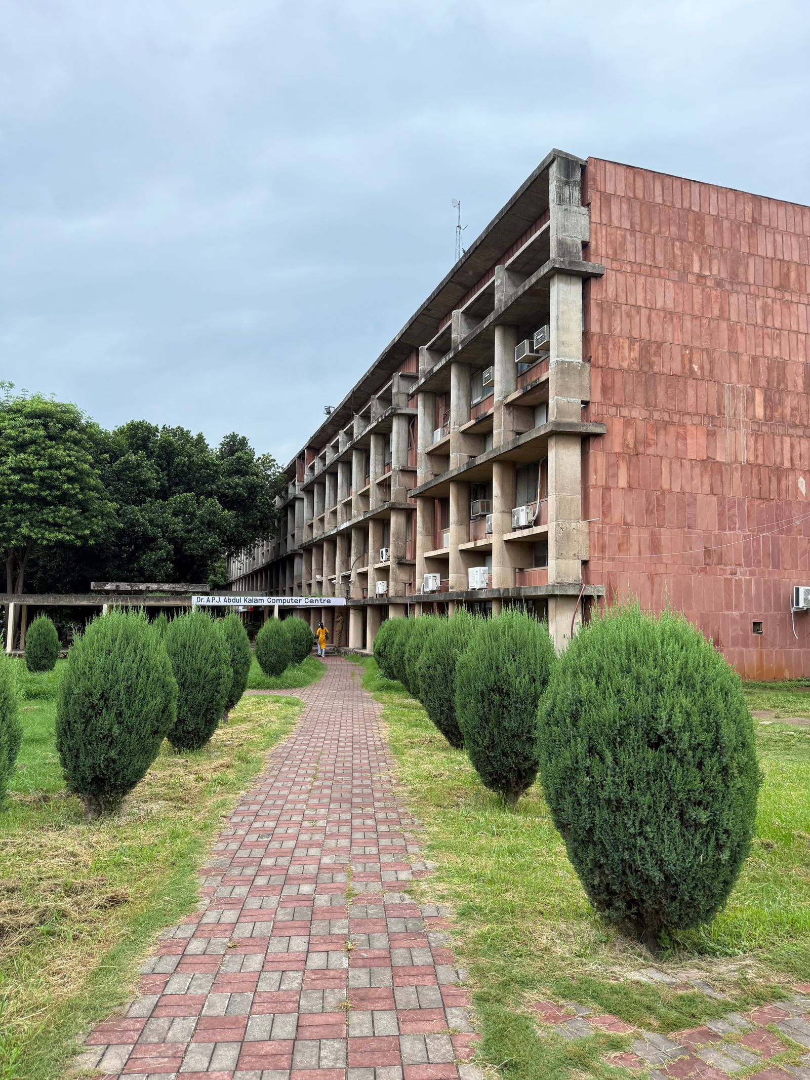 Academic building with a brick pathway on a college campus