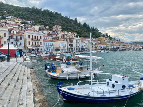 Free Boats docked by the charming hillside town of Gytheio, Greece, on an overcast day. Stock Photo