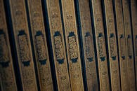 Intricate Arabic Calligraphy on Quranic Book Spines