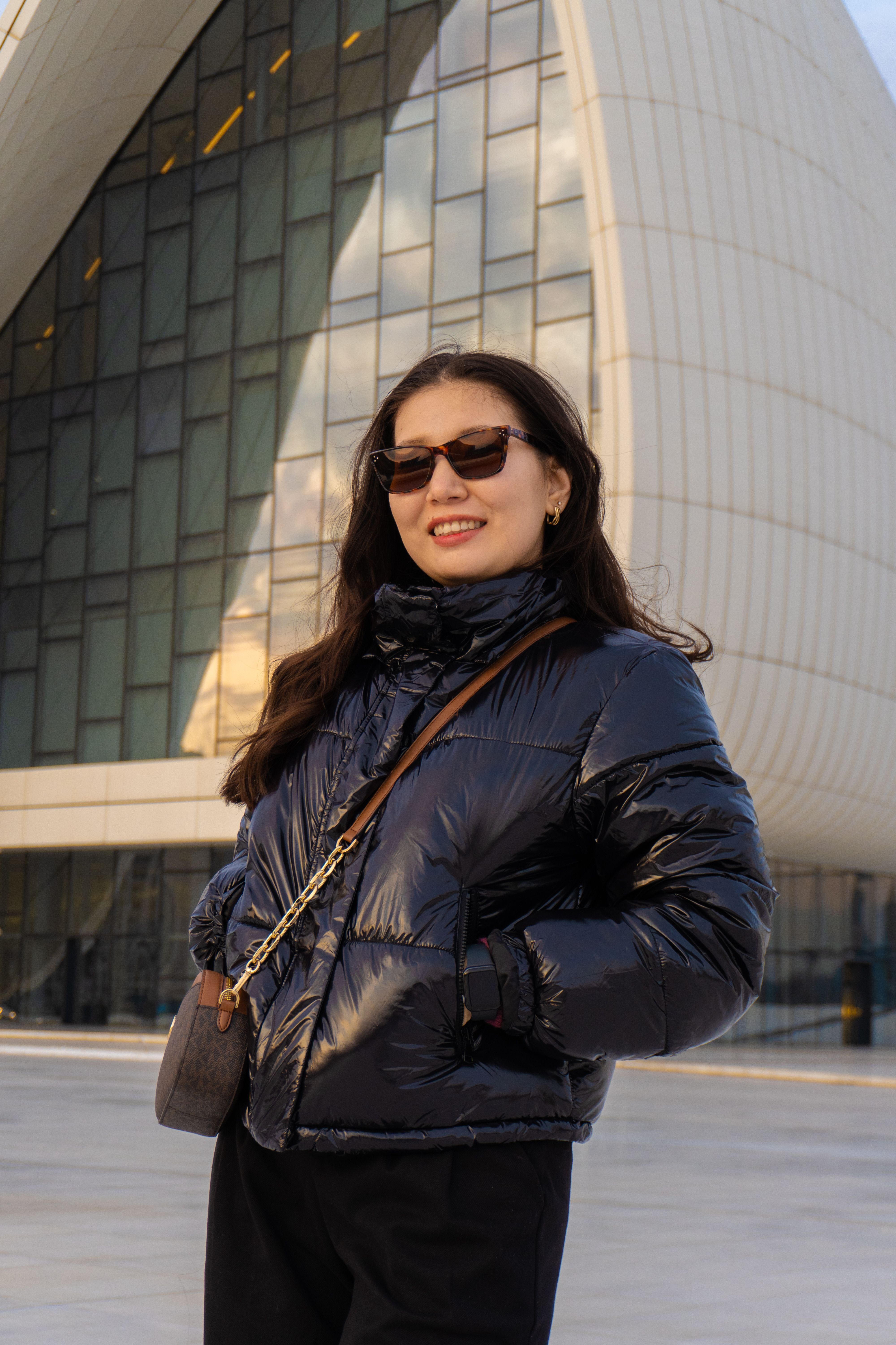 Woman in a warm winter puffer jacket layered over knitwear