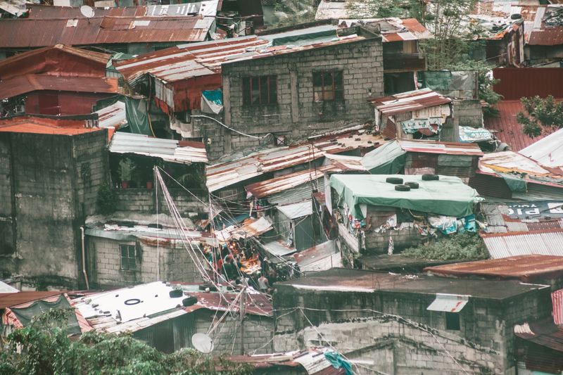 Aerial view of an informal settlement with makeshift rooftops and power lines, South Africa