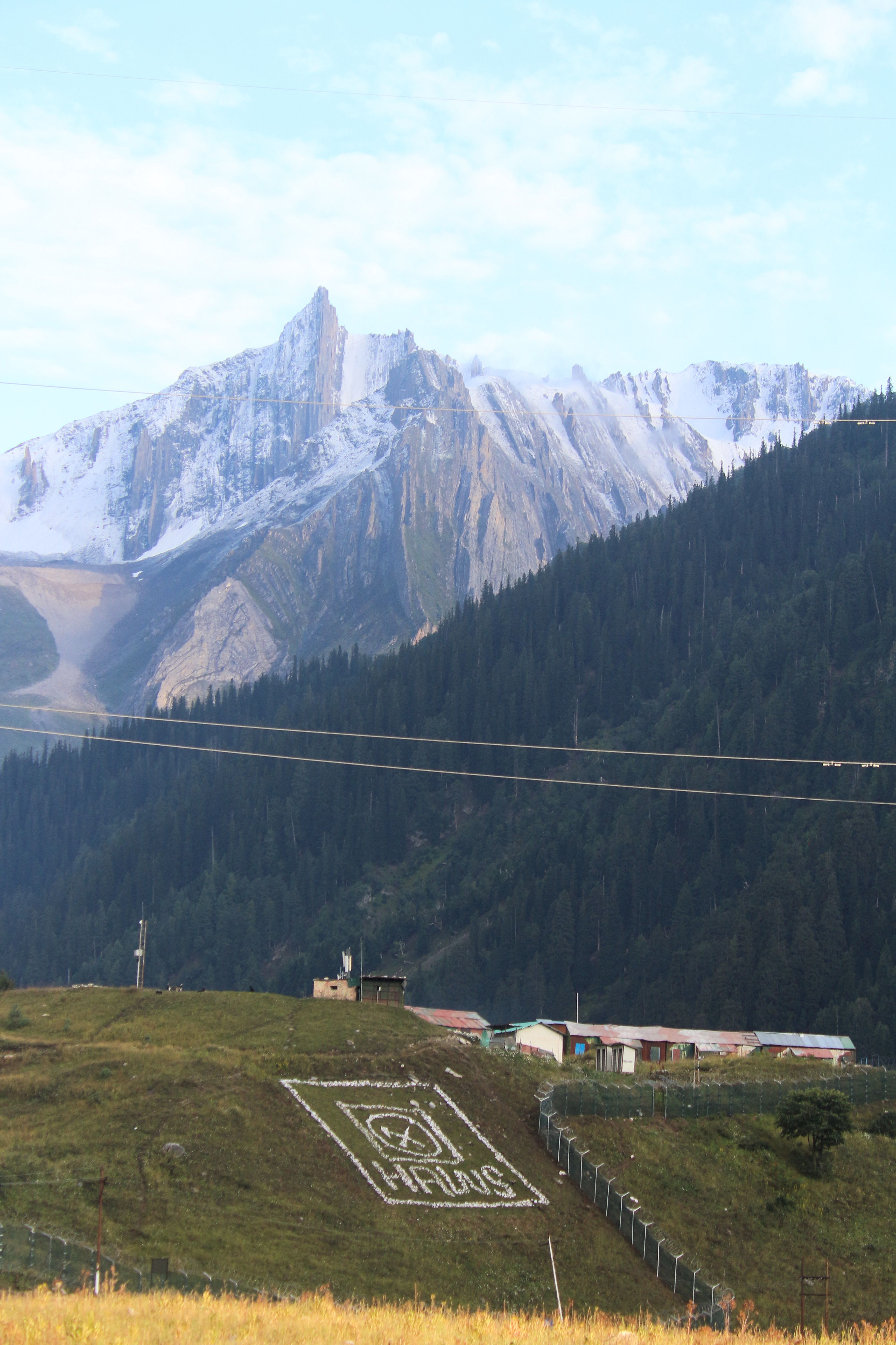 Beautiful mountain landscape with snowy peaks and a small village nestled below.