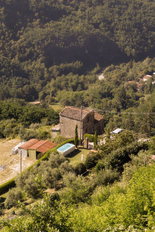 Free A picturesque stone villa with pool nestled in the serene hills of Tereglio, Tuscany. Stock Photo