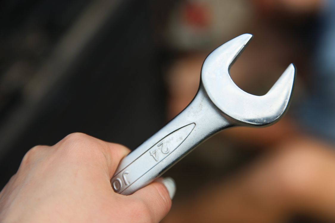 Hand Rench Close-up of a Hand Holding a Metal Wrench · Free Stock Photo