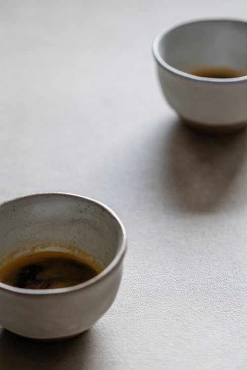 Free Two ceramic tea cups on a soft, neutral background, creating a minimalist aesthetic. Stock Photo