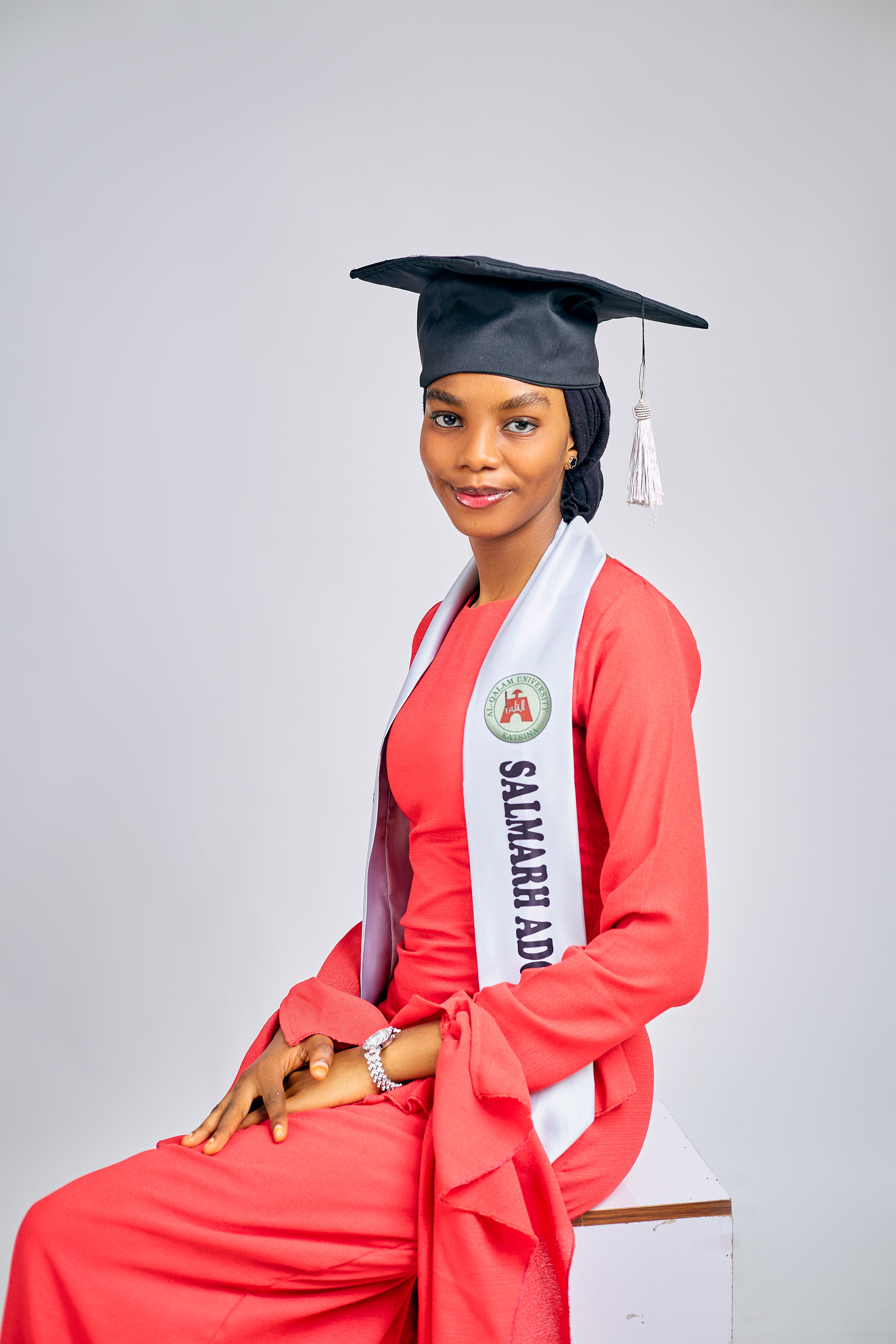 Portrait of a young woman in graduation attire, symbolizing success and achievement.