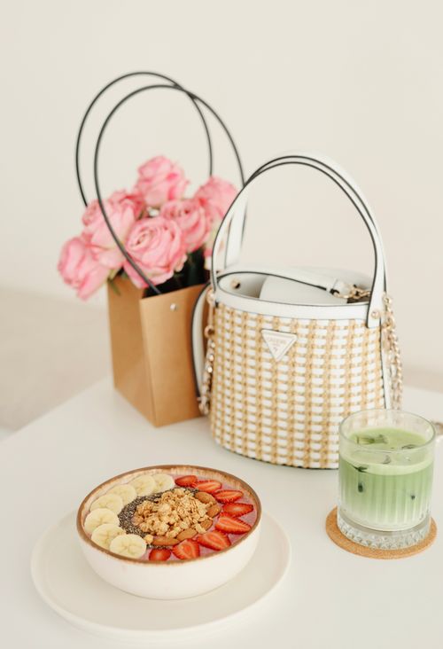 Free Stylish breakfast scene with acai bowl, matcha latte, and roses. Stock Photo