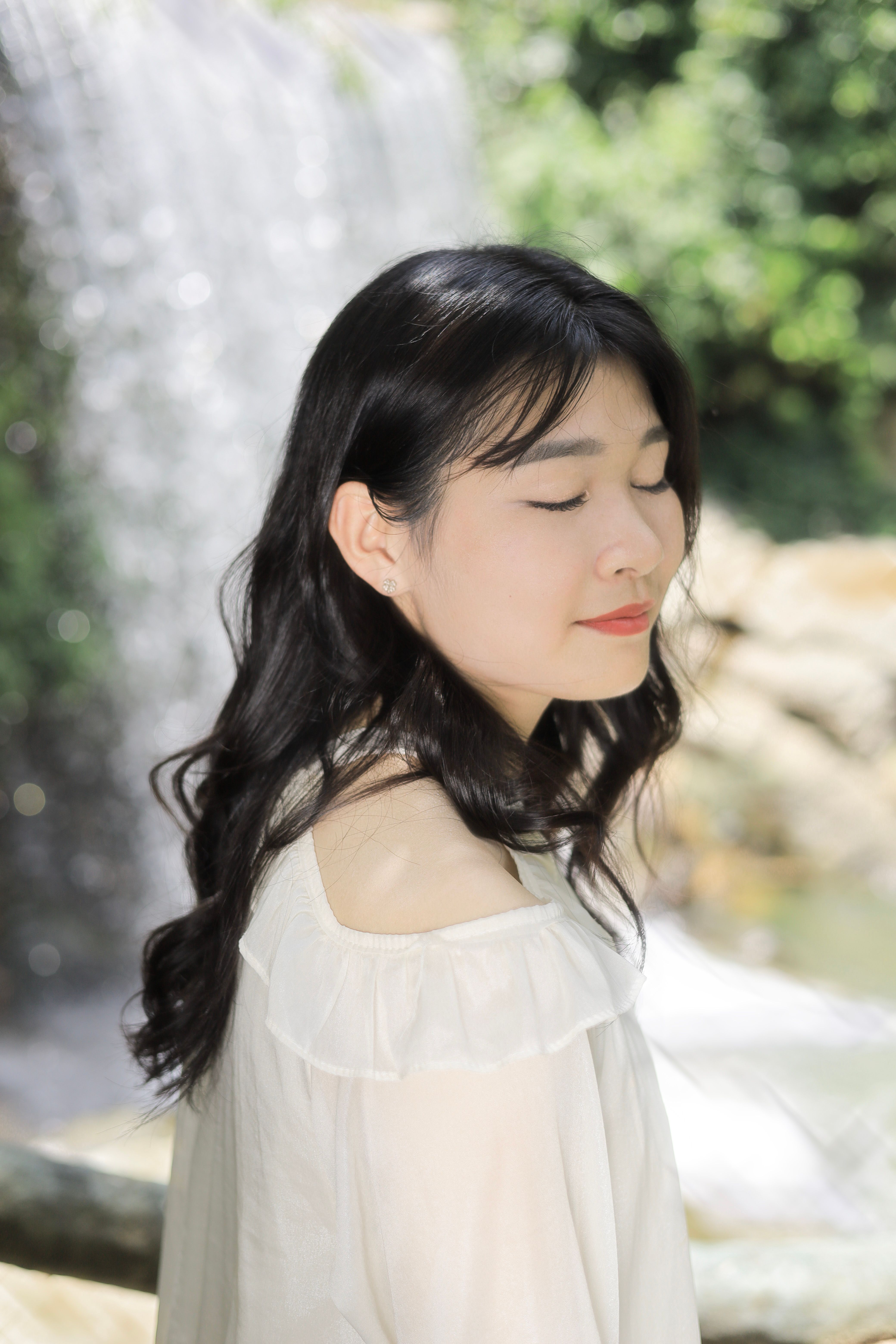 Serene Portrait by Waterfall in Summer · Free Stock Photo
