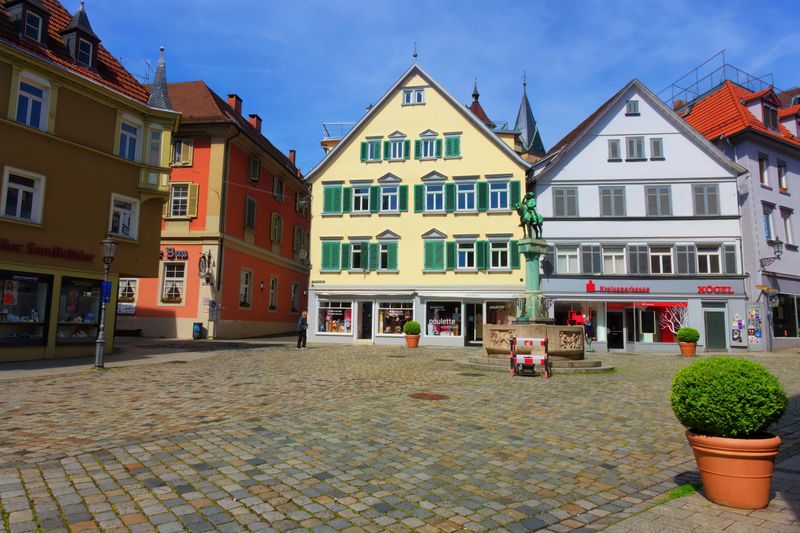 A picturesque view of a historic town square in Esslingen, Germany with colorful facades and cobblestone streets.