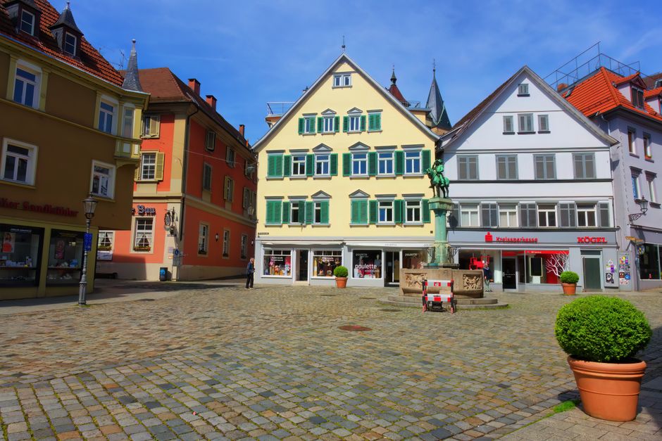 A picturesque view of a historic town square in Esslingen, Germany with colorful facades and cobblestone streets.