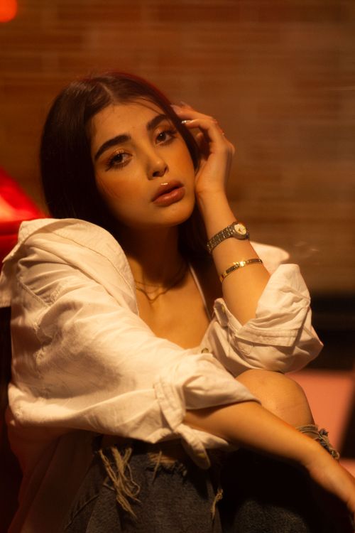 Free Stylish portrait of a young woman with warm lighting, showcasing modern fashion in Tehran. Stock Photo