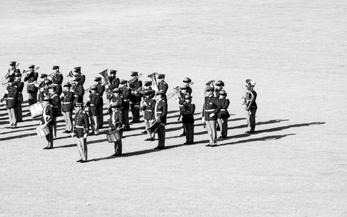 Free Black and white photo of a military band performing outside, emphasizing discipline and order. Stock Photo