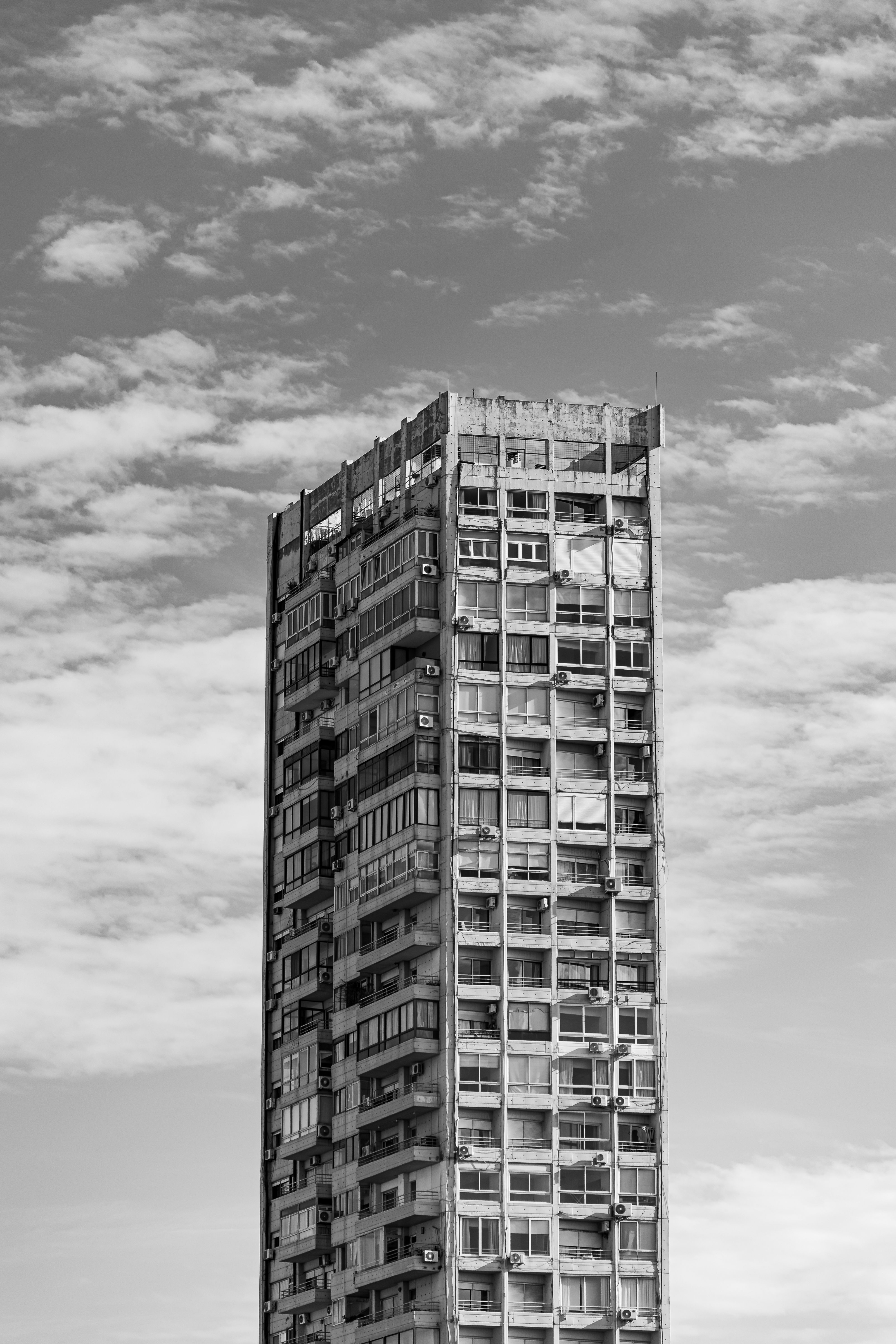 Modern High-Rise Building Against Cloudy Sky · Free Stock Photo