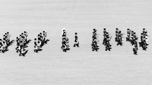 Free Aerial view of a marching band in formation, captured in black and white. Stock Photo