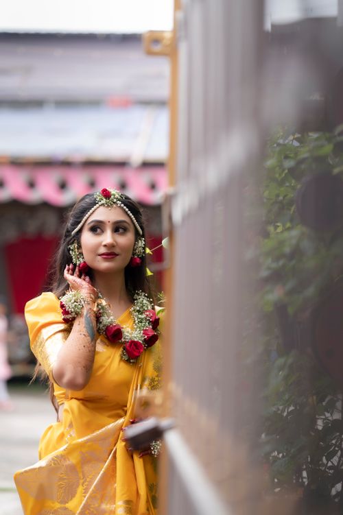 Free Young woman in traditional attire with floral jewelry enjoying an outdoor moment. Stock Photo