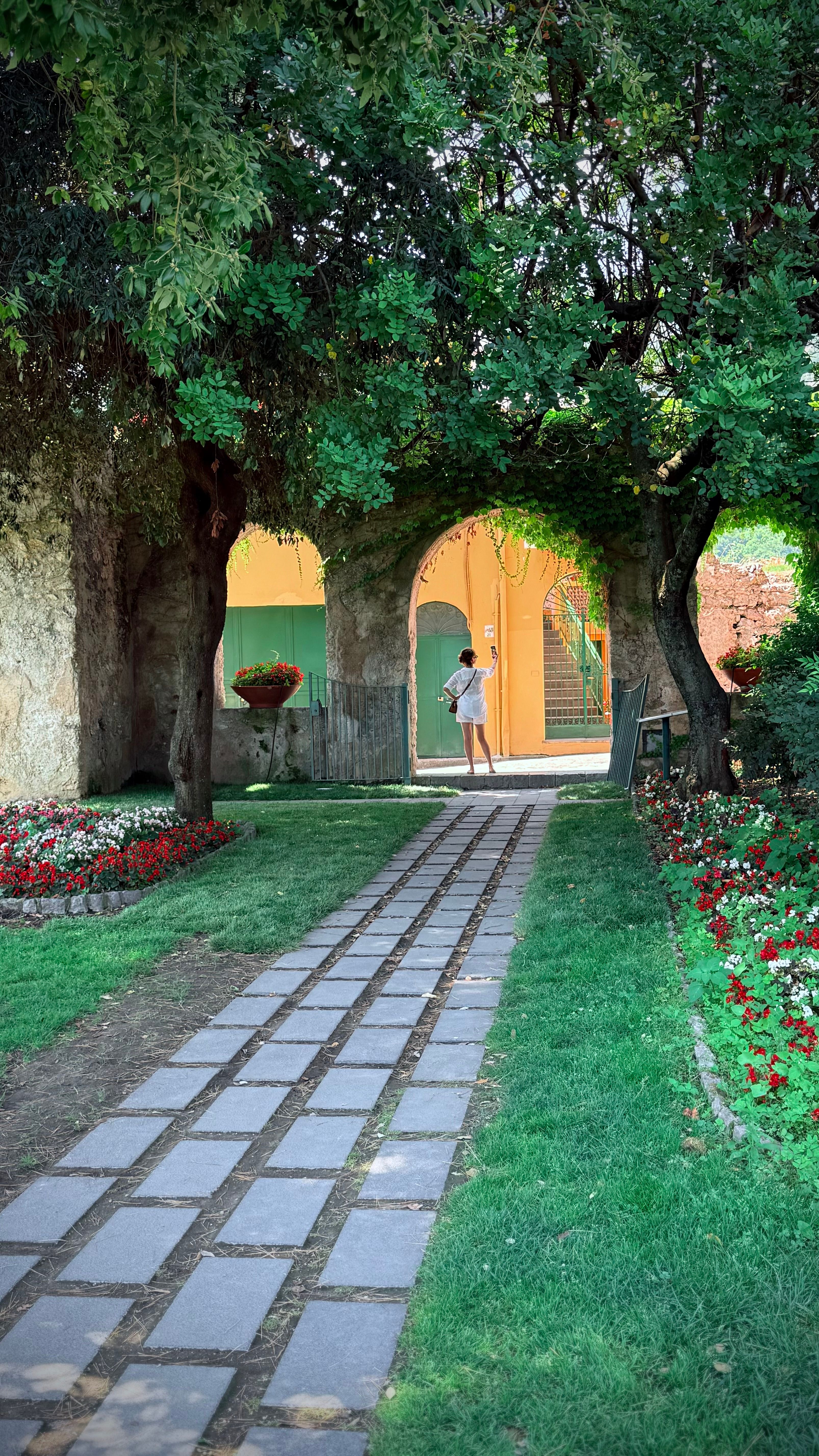 Charming Garden Pathway with Arched Entrance · Free Stock Photo