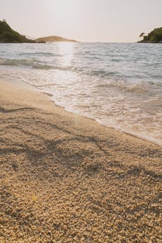 Beautiful sunset over Ksamil beach in Albania, highlighting clear waters and sandy shores.