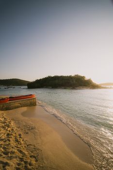 Capture the golden hour beauty of Ksamil beach, Albania, featuring a tranquil seascape and island view.
