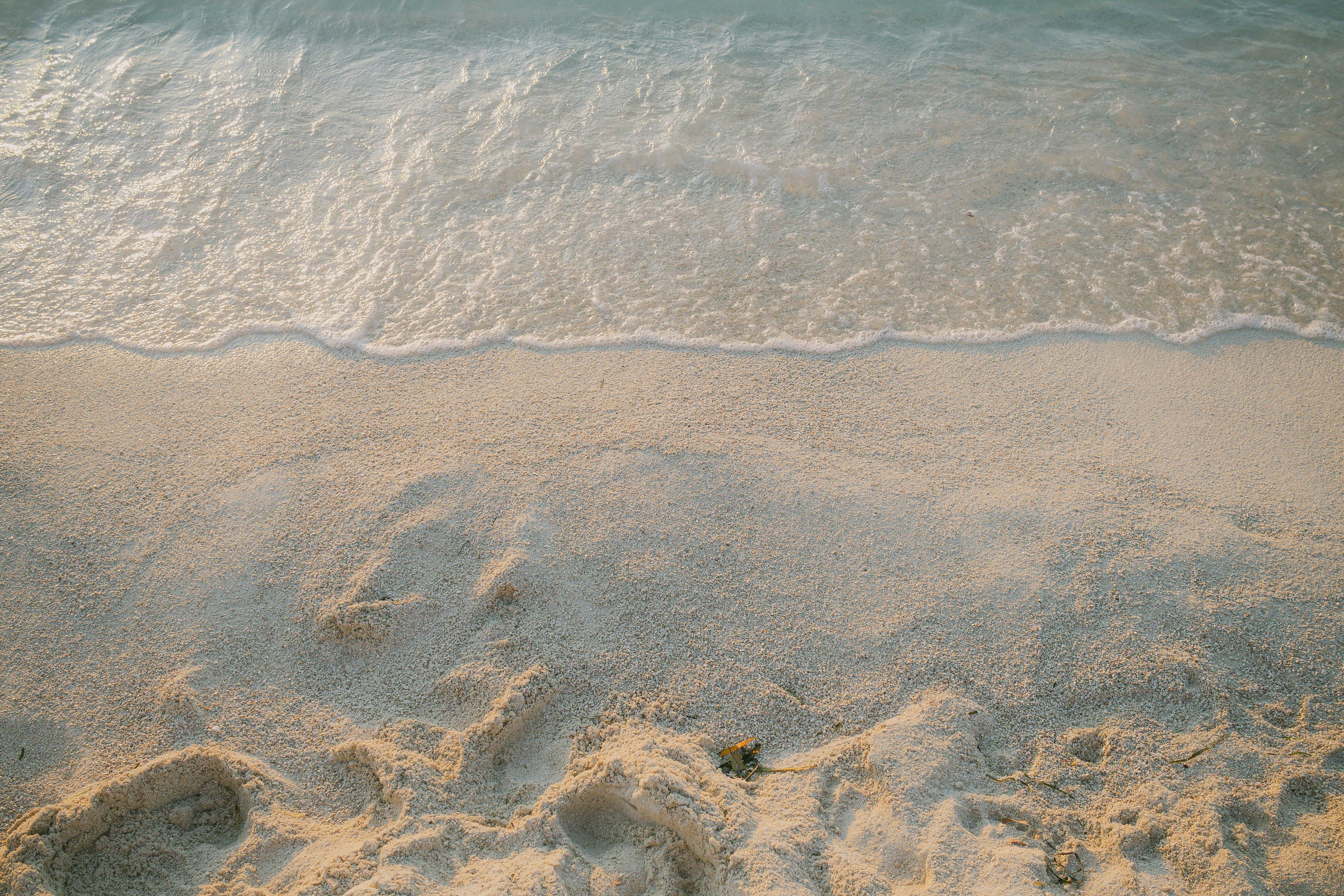 Experience the tranquil beauty of Ksamil's sandy shoreline at sunset, offering a peaceful and idyllic coastal retreat.