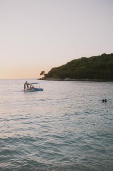 Enjoy a tranquil sunset with clear waters at Ksamil Beach in Albania, perfect for a relaxing vacation.