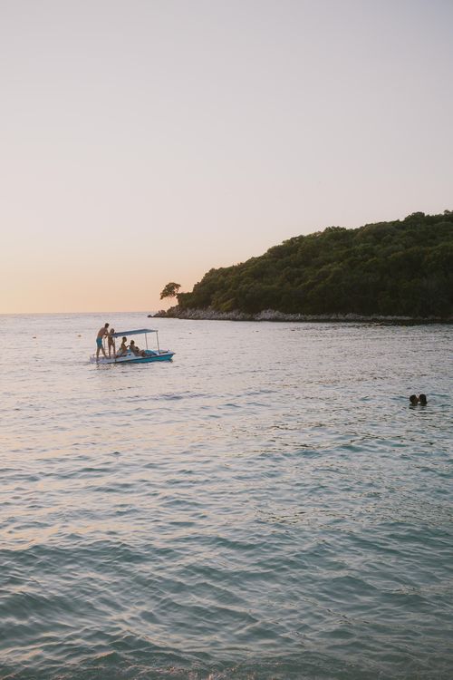 Free Enjoy a tranquil sunset with clear waters at Ksamil Beach in Albania, perfect for a relaxing vacation. Stock Photo