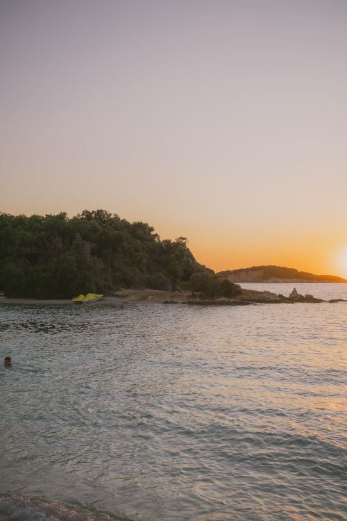 Free Experience the tranquil beauty of Ksamil Beach, Albania, during a stunning sunset. Stock Photo