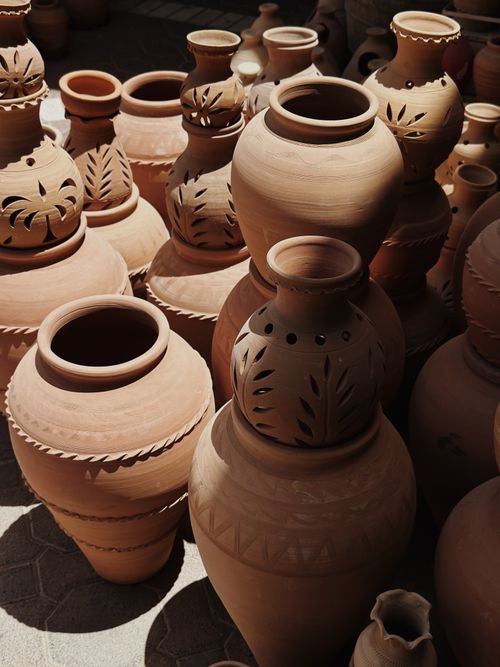 Free A collection of handcrafted clay pots with decorative patterns under natural sunlight. Stock Photo