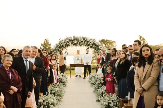 Outdoor wedding ceremony with guests during sunset in São Paulo, Brazil.