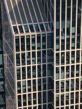 Close-up of a modern glass skyscraper facade showcasing architectural symmetry.
