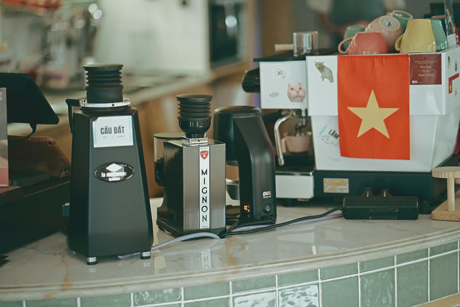 Coffee grinders and espresso machine on a cafe counter setup