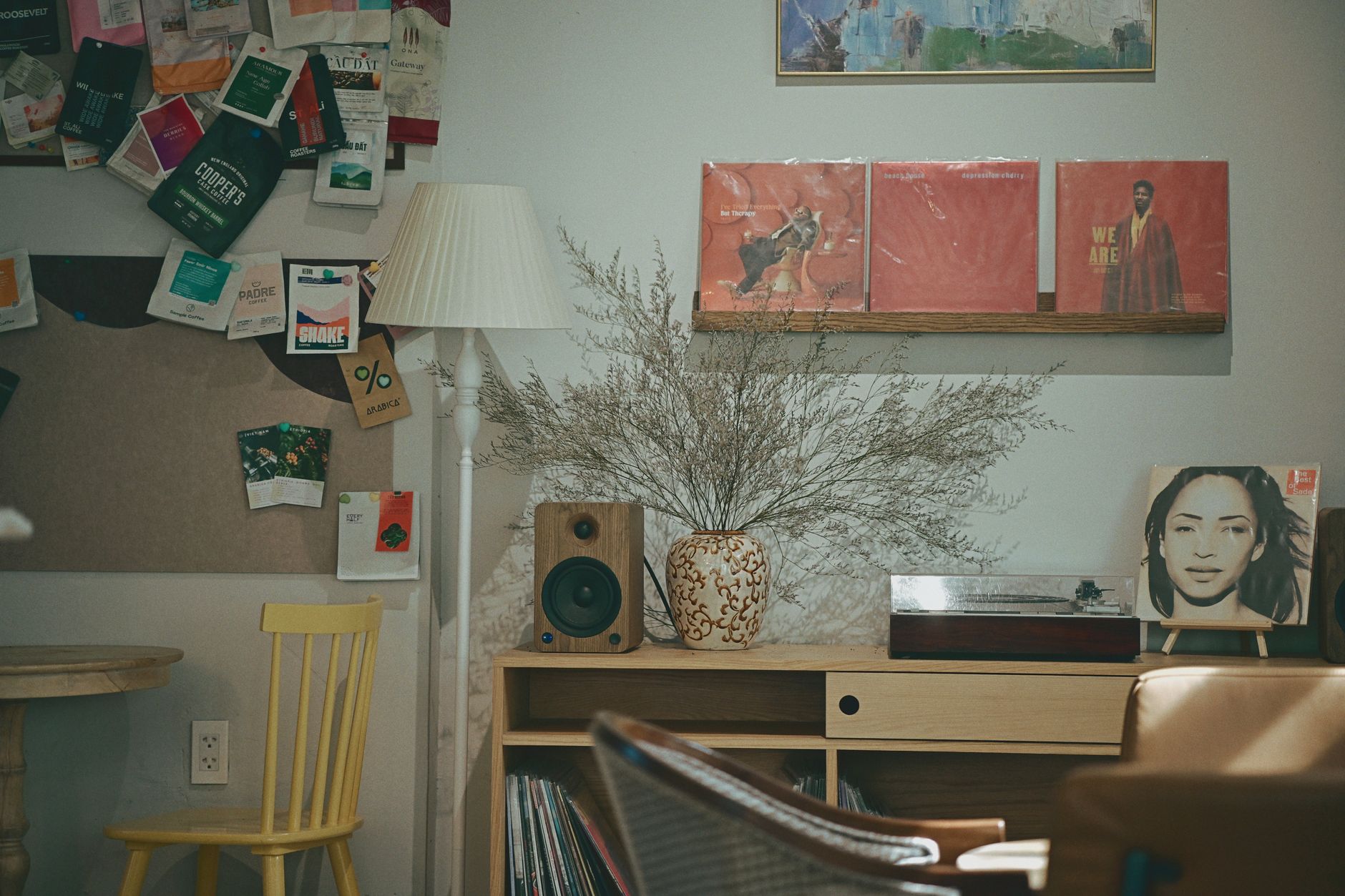 Retro styled room featuring vinyl records, speaker, and decor items for a cozy atmosphere.