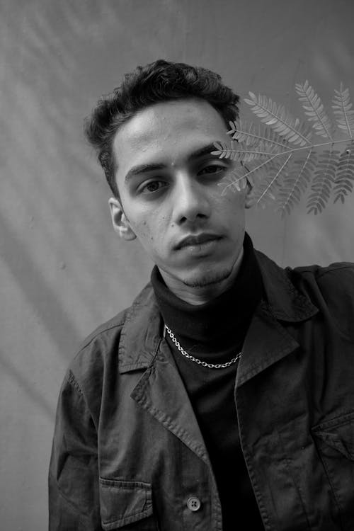 Grayscale Photography of Man Wearing Black Collared Shirt