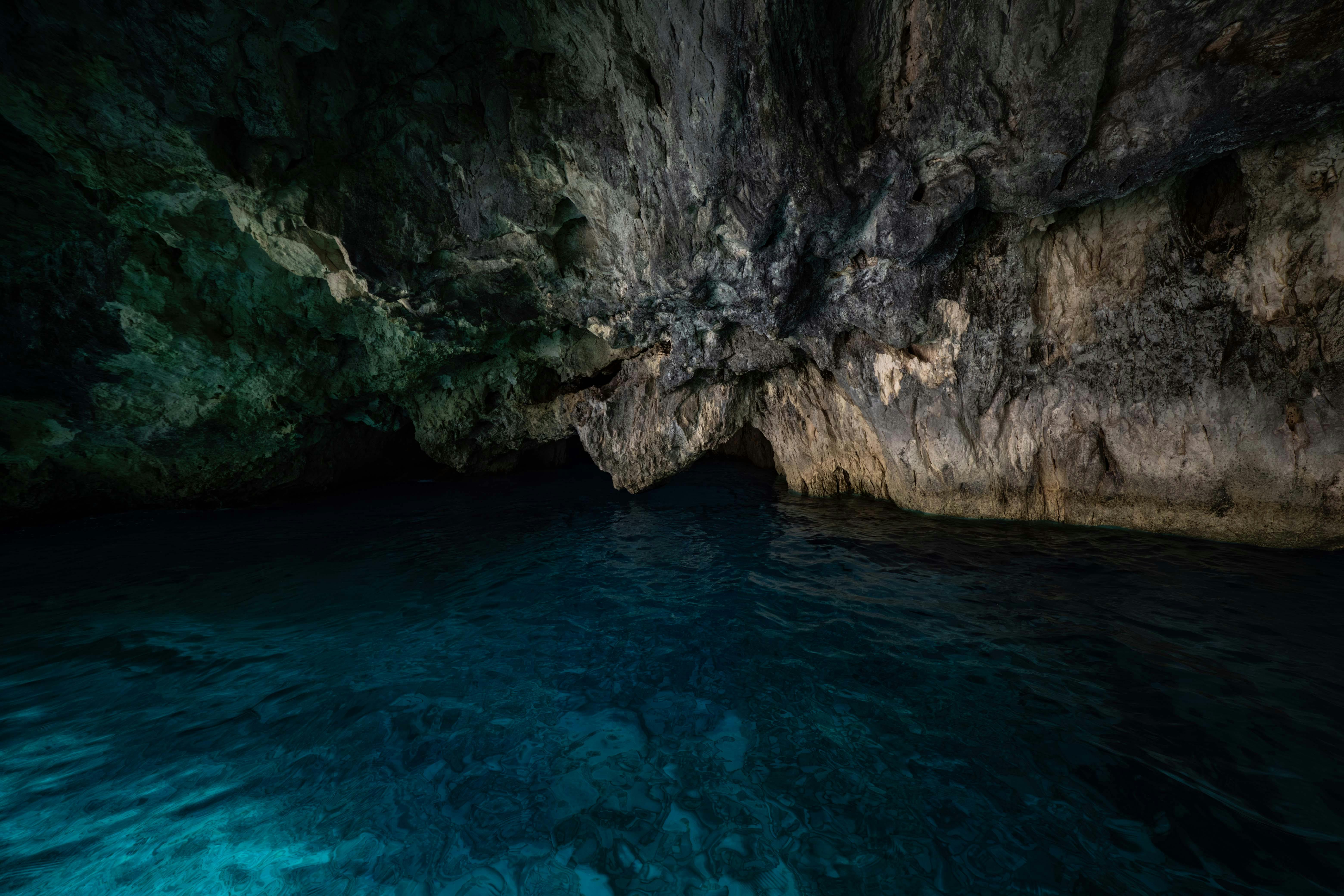 A serene but mysterious underwater cave entrance, inviting exploration. - best books on cave diving