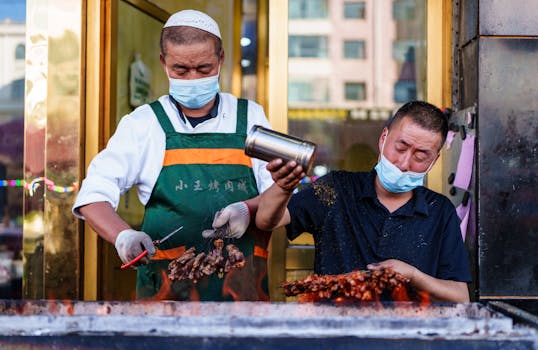Street food vendors grilling meat skewers in Haibei, Qinghai, China, showcasing traditional Chinese barbecue techniques.