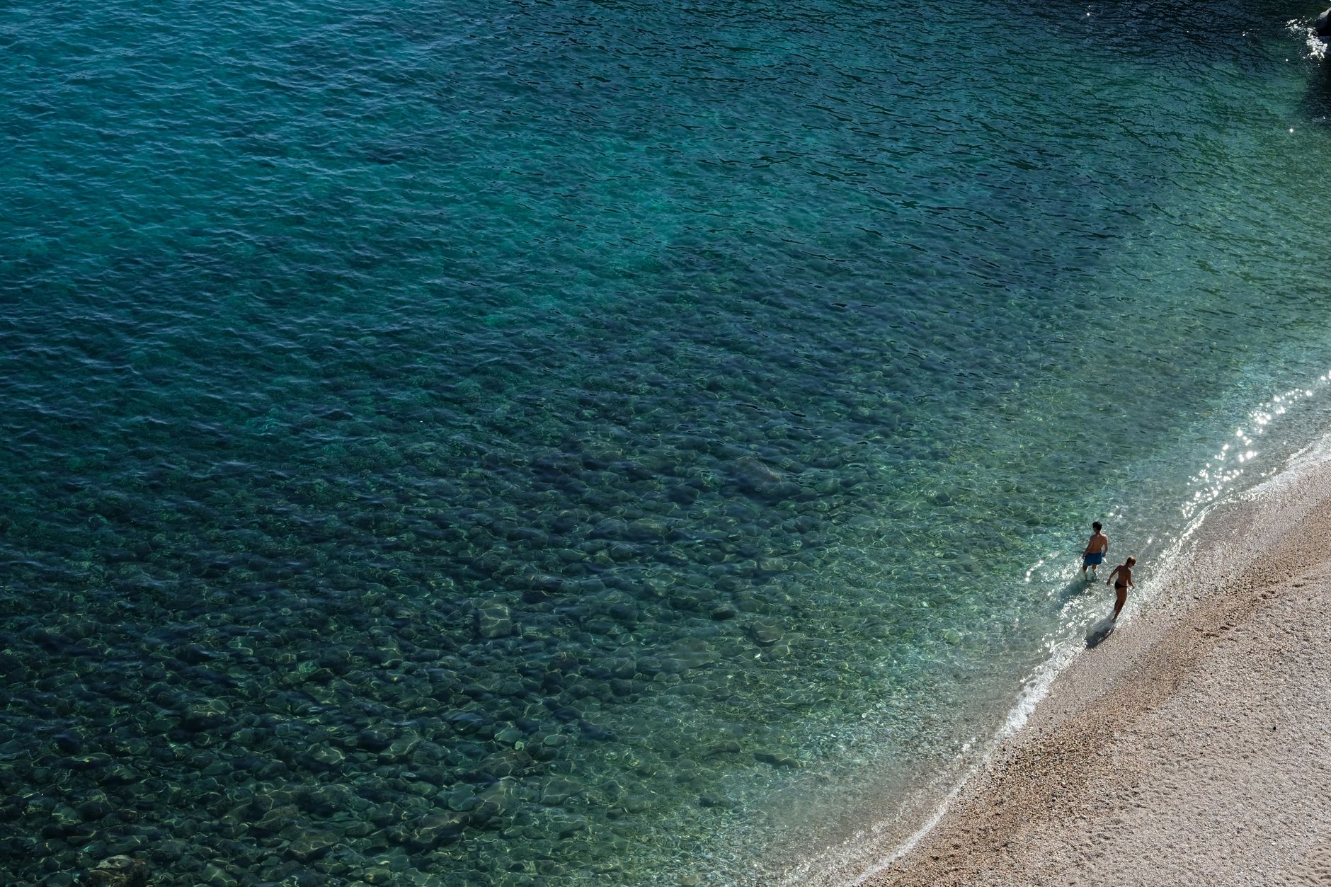A sunny day at Thasos, Greece, with clear turquoise waters and relaxing beach strolls.