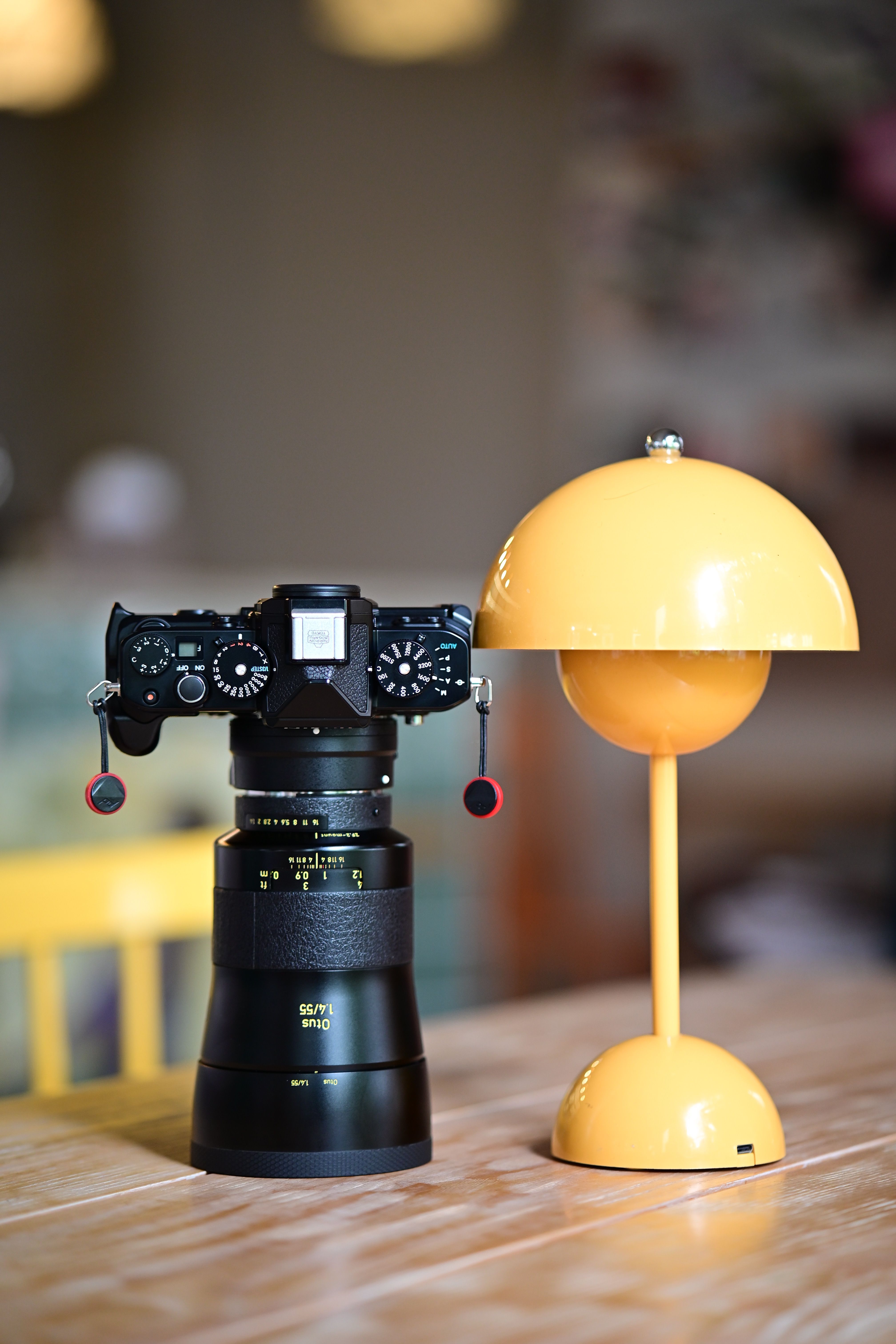 DSLR Camera and Yellow Lamp on Table · Free Stock Photo