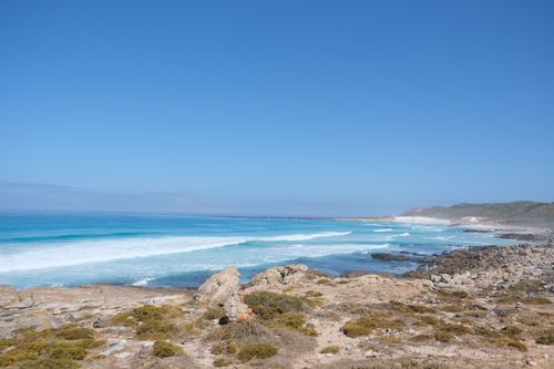 Free Vast coastal view showcasing the rugged beauty of Cape Town's shoreline under a clear blue sky. Stock Photo