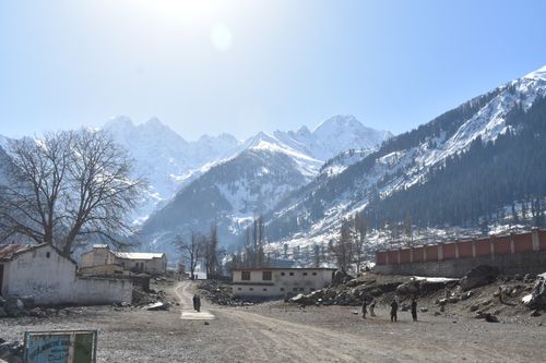Free Scenic winter view of snowy mountains and rural landscape in Kalam, Khyber Pakhtunkhwa, Pakistan. Stock Photo